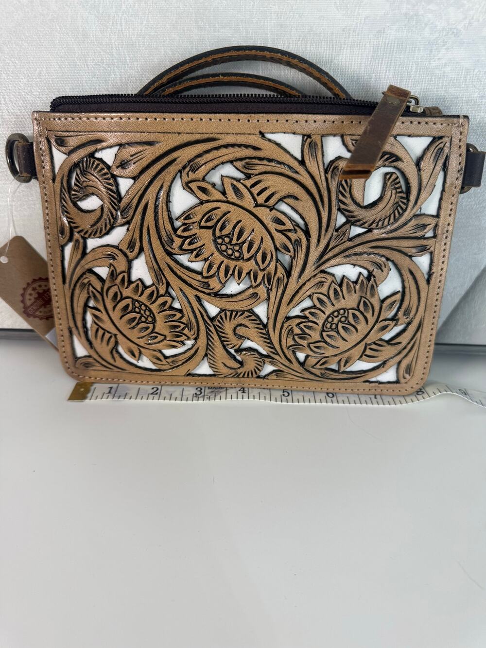Genuine western floral tooled leather crossbody bag.